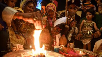 A Pakistani Hindu couple at a mass wedding ceremony in Karachi, on March 19, 2017. Some 62 Hindu couples participated in the ninth mass-marriage ceremony organised by Pakistan Hindu Council, as part of the Holi celebrations. Asif Hassan / AFP