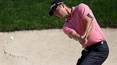 The German golfer Martin Kaymer plays his way out of trouble at the Abu Dhabi Championship.