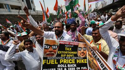 Activists of India's main opposition National Congress Party hold placard and shout slogan as they protest against the hike in fuel prices in Mumba. EPA/DIVYAKANT SOLANKI