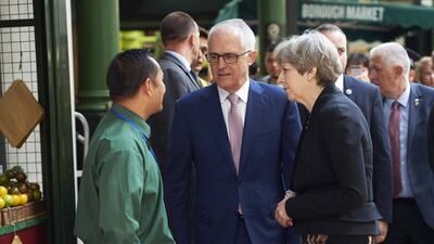Theresa May and Malcolm Turnbull speak with a market trader during a visit to the scene of the London Bridge terror attack that left eight dead