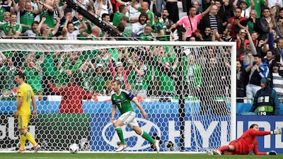 Northern Ireland midfielder Niall McGinn, centre, celebrates scoring against Ukraine goalkeeper Andriy Pyatov. Jeff Pachoud / AFP