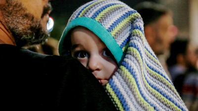 A child was among the hundreds of civilians who arrived at a military airport in Amman on Monday after being evacuated from Sudan. AFP