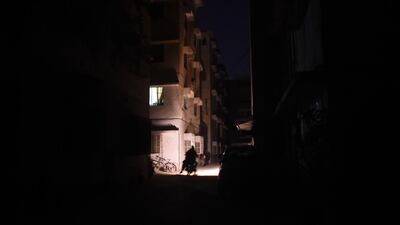 A motorcyclist rides through a residential area during a power blackout in Pakistan's port city of Karachi early. AFP