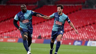 Joe Jacobson of Wycombe Wanderers celebrates with Adebayo Akinfenwa of Wycombe Wanderers after he scores from the penalty spot against Oxford United. Getty