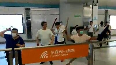 Men in white shirts and face masks attack anti-extradition bill demonstrators and reporters at a train station in Hong Kong, China. Courtesy of Stand News / Social Media via Reuters