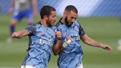 Eden Hazard bumps shoulders with Karim Benzema as they warm up. Getty