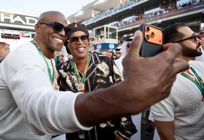 Terry Crews and Ronaldinho Gaucho in the paddock at Yas Marina. Chris Whiteoak / The National