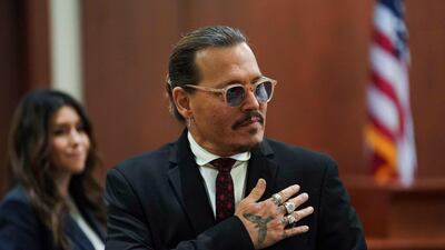 Depp acknowledges supporters before a lunch break. AFP