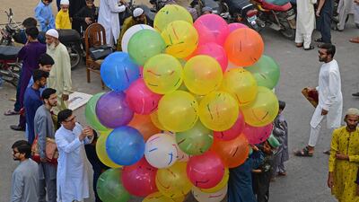 A street vendor offers balloons for sale to mark the Eid celebration in Karachi, Pakistan. AFP