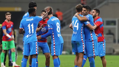 Luis Suarez celebrates with Marcos Llorente of Atletico Madrid after the Champions League Group B match win against AC Milan at Giuseppe Meazza Stadium on September 28, 2021 in Milan, Italy. Getty Images