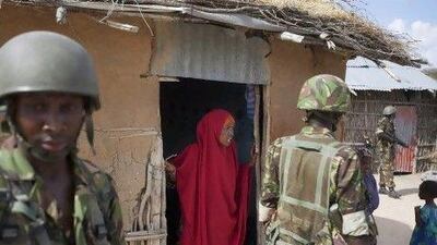 Somali villagers, such as this woman talking to Kenyan troops, are keen to get Al Shabab fighters out of their area to allow food aid in.