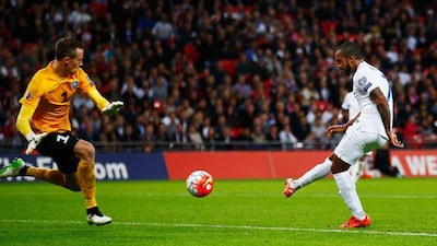 England’s Theo Walcott shoots past Estonia keeper Mihkel Aksalu for the team’s first goal on Friday night in their 2-0 Euro 2016 qualifying victory. Clive Rose / Getty Images