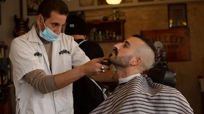 A customer at Nashville Barber Shop gets a shave after coronavirus restrictions were eased, opening shopping centres, gyms, barber shops, among other sites in Jerusalem.