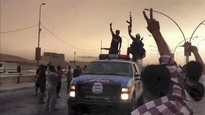 An image grab taken from a video uploaded on Youtube on June 12, 2014, allegedly shows Islamic State of Iraq and the Levant (ISIL) militants taking part in a military parade in the northern city of Mosul. Iraqi security forces found the burned bodies of 12 policemen when they recaptured a town north of Baghdad from militants, a police colonel and a doctor said. AFP