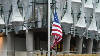 A soldier salutes as the American flag is raised at the Nine Elms embassy building for the first time in January 2018. Getty Images