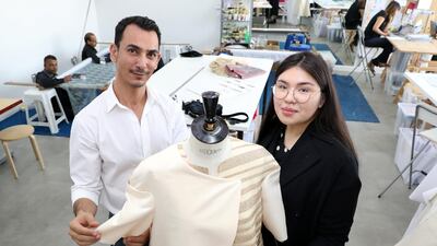 Rami Al Ali and Karashash Nurakhmet, winner of his summer internship, with one of her designs at his Dubai Design District atelier. Chris Whiteoak / The National