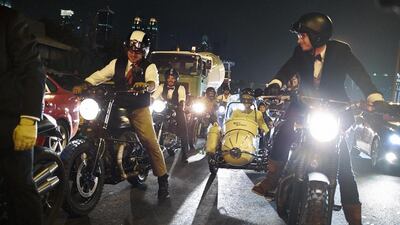 A brief traffic light stop brings the sixty plus rider procession to a halt near its destination in Jumeirah for the Distinguished Gentleman’s Ride 2014 in Dubai.