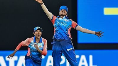 Mumbai Indians' Sajeevan Sajana after taking a catch to dismiss Delhi Capitals' captain Meg Lanning. AFP
