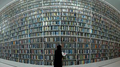 A visitor checks a book at the Mohammed Bin Rashid Library. AFP