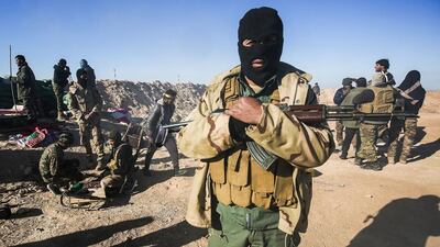 A masked fighter of Iraq’s government-backed Hashed Al Shaabi militias near the town of Tal Afar, west of Mosul, on February 18, 2017. Iraqi forces have relied on informants in their campaign to retake the eastern half of Mosul from ISIL and are now preparing for an offensive on the western side. Ahmad Al Rubaye / AFP