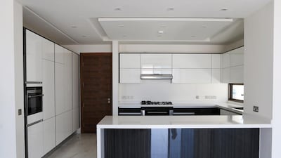 The four-bed villa includes a maid’s room, a double garage and the kitchen is fully fitted to include Miele appliances and the house is fitted with whizzy controls which enables its inhabitants to remotely change the temperature and lighting and even open the curtains. Pawan Singh / The National