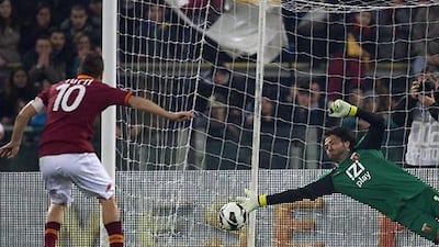 Roma captain Francesco Totti fires home from the penalty spot against Genoa to become Italy's joint second-top goalscorer.
