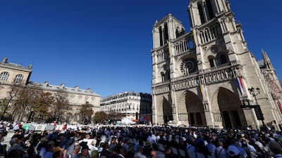 The faithful wait for Pope Leo's arrival at Notre-Dame Cathedral in Paris. Getty Images