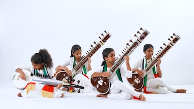 Wearing white to denote peace, young musicians felt 'calm and strong' when playing the UAE national anthem in harmony. Photo: Malhaar