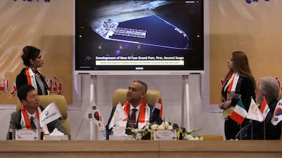 An image is of Iraq’s Grand Al Faw Port project is displayed on a screen as the director general of the General Company for Ports, Farhan Al Fartousi, signs a construction contract with South Korea’s Daewoo Engineering & Construction in Baghdad on December 30, 2020. Reuters
