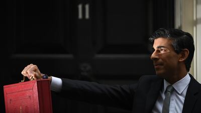 Rishi Sunak didplays the budget box to the waiting media. Getty Images
