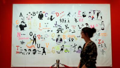 A woman looks at an artwork by Donald Urquhart called "A Michael Jackson Alphabet" on display at the "Michael Jackson: On the Wall" at the National Portrait Gallery in London, Britain, on June 27, 2018. Kirsty Wigglesworth / AP Photo