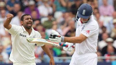 India's Praveen Kumar, left, celebrates the dismissal of Andrew Strauss, the England captain, at Nottingham on Friday.