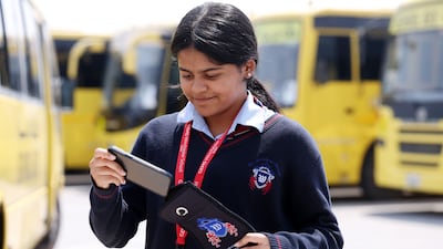 A pupil puts her phone into her Fixby pouch as she arrives at school