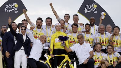Tadej Pogacar celebrates on the podium with his UAE Team Emirates-ERG crew after winning the 2025 Tour de France. EPA