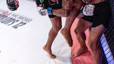 Bruno Machado sinks his knee into Mike Santiago. Credit UAE Warriors