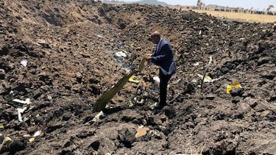 In this photo taken from the Ethiopian Airlines Facebook page, the CEO of Ethiopian Airlines, Tewolde Gebremariam, looks at the wreckage of the plane. AP Photo