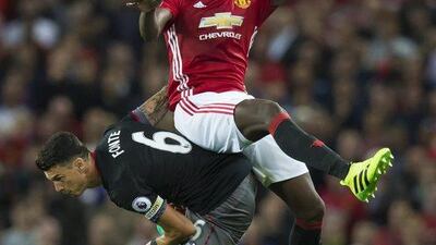Manchester United’s Paul Pogba, top, fights for the ball against Southampton’s Jose Fonte during the Premier League match between Manchester United and Southampton at Old Trafford Stadium, Manchester, England, Friday, August 19, 2016. Jon Super / AP Photo