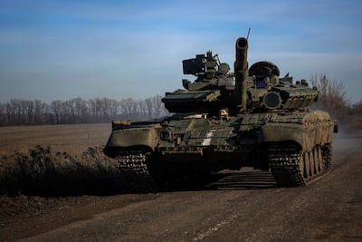 A Ukrainian tank drives down a road near Bakhmut in the Donetsk region. AFP