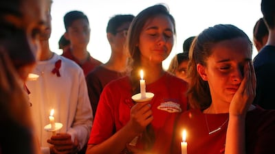 Students gather to grieve during a vigil at Pine Trails Park. Brynn Anderson / AP Photo
