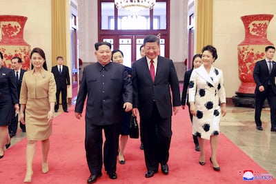 North Korean leader Kim Jong-un and his wife Ri Sol-ju walking with Chinese President Xi Jinping and his wife Peng Liyuan during their meeting in China. EPA / KCNA