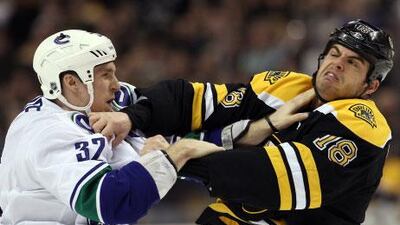 Fighting is down this year in the NHL, but Toronto general manage Brian Burke says that could be a problem and that he notices players are doing less policing of themselves, such as Nathan Horton, right, getting into a fight with Vancouver's Dale Weise in early January, which was a bit of payback for Vancouver knocking Horton out of the Stanley Cup finals with a concussion.