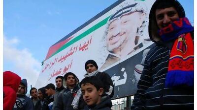 Home supporters in the stands beneath a giant poster of Yasser Arafat, the late Palestine leader.