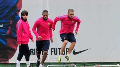 Lionel Messi, left, Eric Abidal and Daniel Alves take part in training yesterday