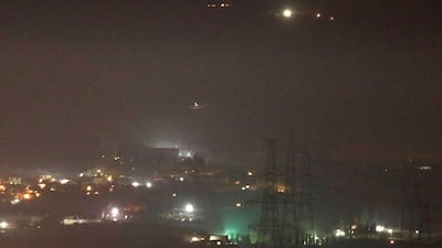 Smoke rises past a mountain as seen from Damascus countryside, Syria. Reuters