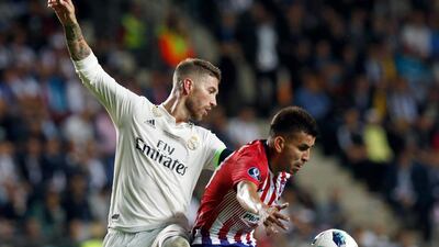 Ramos and Atletico's Angel Correa challenge for the ball. AP