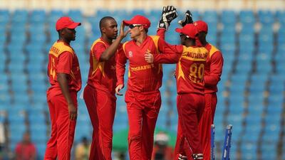 Zimbabwe Tinashe Panyangara (2L)celebrates with teammates after his dismissal of Afghanistan batsman Gulabdin Naib during The World T20 cricket tournament match between Afghanistan and Zimbabwe at The Vidarbha Cricket Association Stadium in Nagpur on March 12, 2016. / AFP / PRASHANT BHOOT
