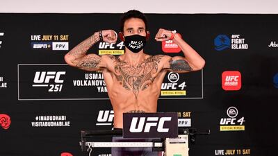 Max Holloway poses on the scale during the UFC 251 official weigh-in.