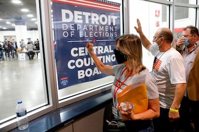 Supporters of US President Donald Trump bang on the glass and chant slogans outside the room where absentee ballots for the 2020 general election are being counted in Detroit, Michigan, on November 4.AFP Photo