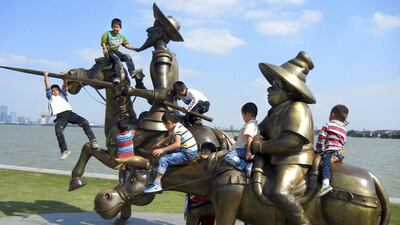 Children play on statues of Don Quixote and Sancho Panza, characters from writer Miguel de Cervantes Saavedra's book "Don Quixote de la Mancha", next to Jinji Lake in Suzhou, Jiangsu province. Reuters/China Daily