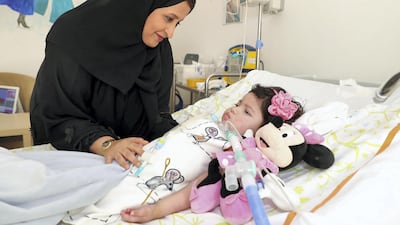 Mira bin Touq has had to watch as her two-year-old daughter Osha has gradually lost her ability to smile, and now only communicates through eye movements. Chris Whiteoak / The National